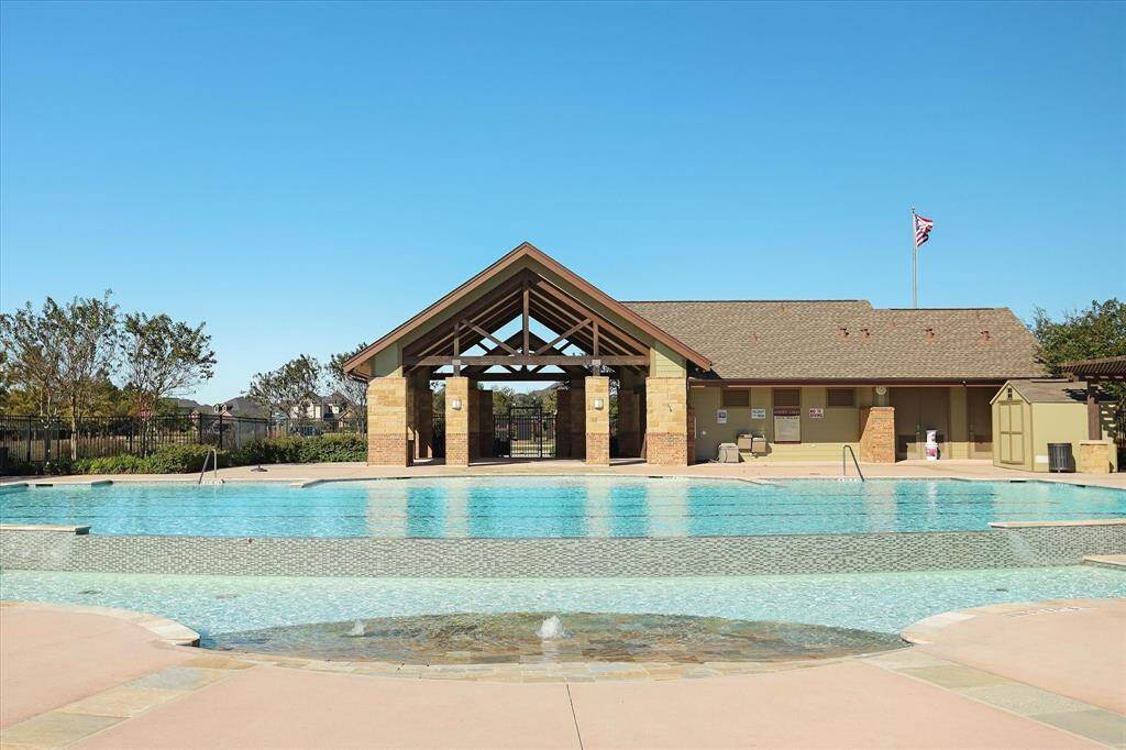 The Hayden Lakes community offers a spacious outdoor pool area with a modern pavilion, perfect for relaxation and gatherings. The well-maintained landscaping enhances the inviting atmosphere.