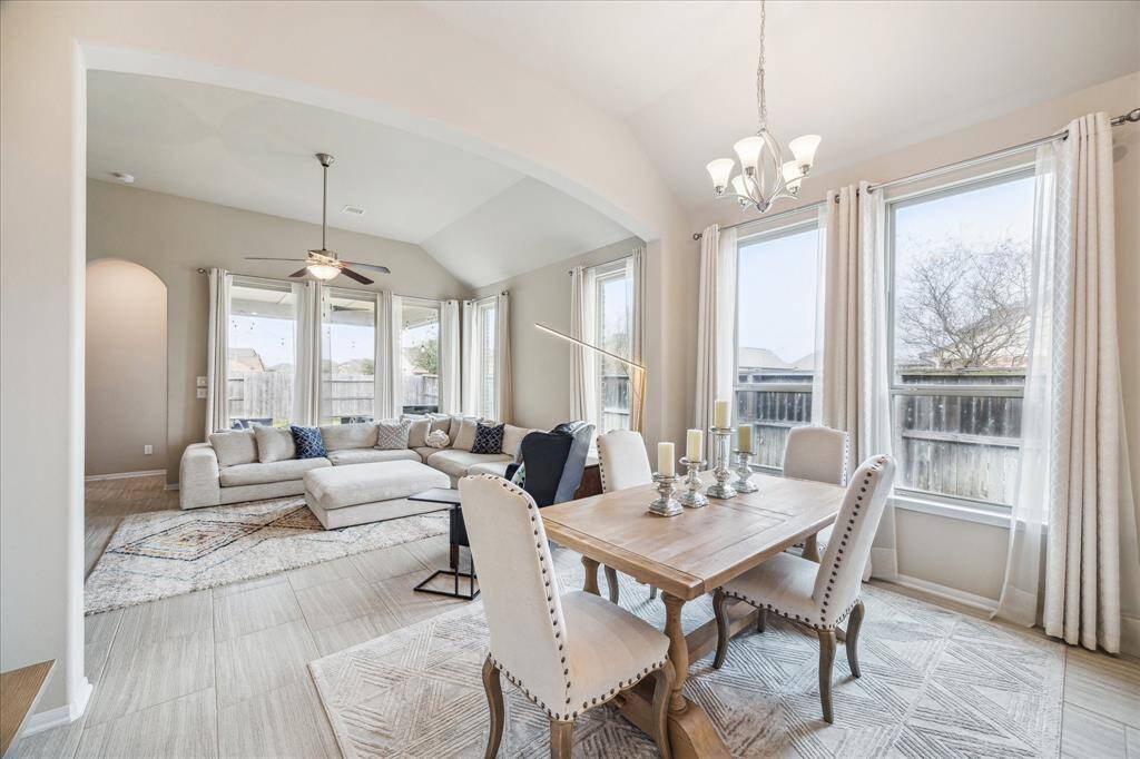 Bright, open-concept living and dining area with large windows, neutral tones, and elegant finishes. This space is perfect for entertaining and family gatherings.