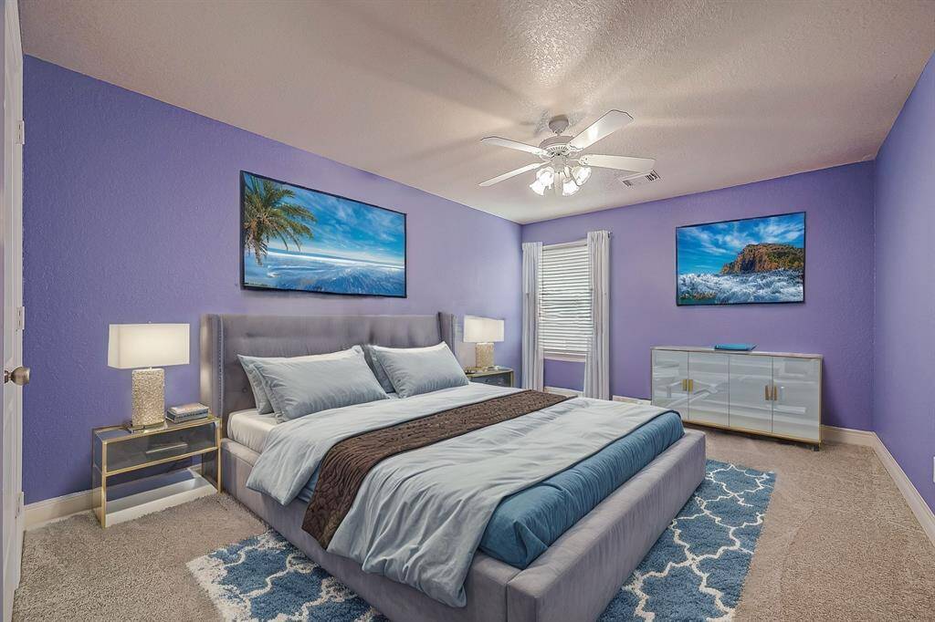 This, one of five secondary bedrooms, is conveniently located just off the game room features LED-lit ceiling fan, fresh carpeting (installed in 2022), fresh paint and ample space for all your furniture.(Virtual Stage)