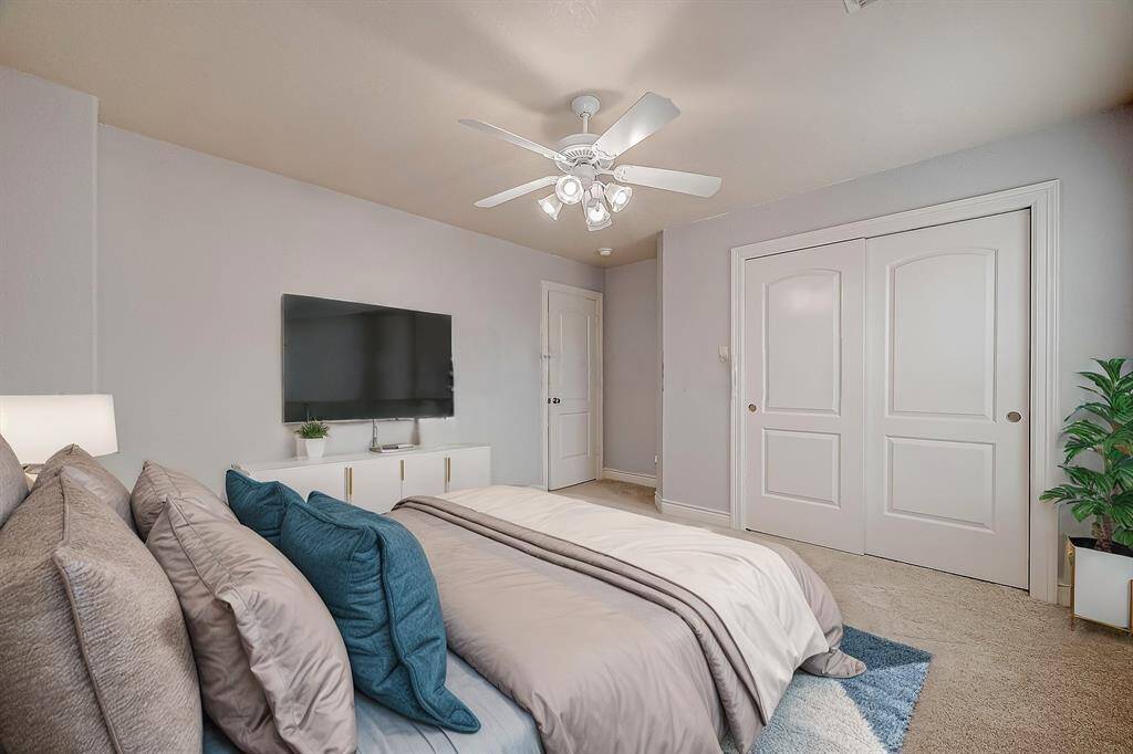 This, one of five secondary bedrooms, is conveniently located just off the game room features LED-lit ceiling fan, fresh carpeting (installed in 2022), fresh paint and ample space for all your furniture.(Virtual Stage)