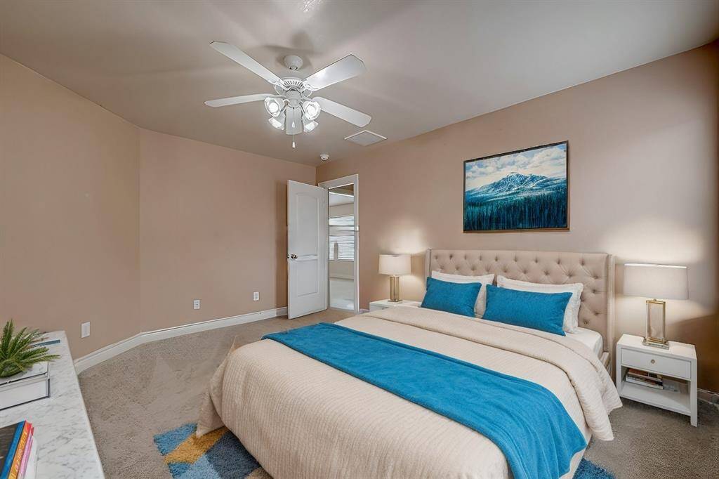 This, one of five secondary bedrooms, is conveniently located just off the game room features LED-lit ceiling fan, fresh carpeting (installed in 2022), fresh paint and ample space for all your furniture.(Virtual Stage)