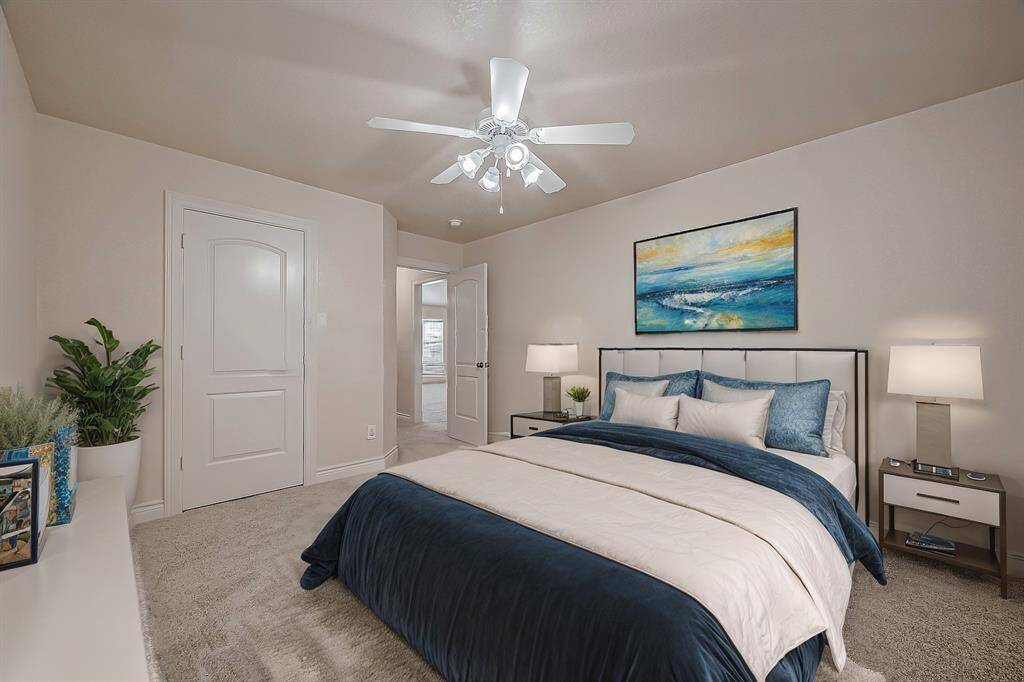 This, one of five secondary bedrooms, is conveniently located just off the game room features LED-lit ceiling fan, fresh carpeting (installed in 2022), fresh paint and ample space for all your furniture.(Virtual Stage)(Virtual Stage)