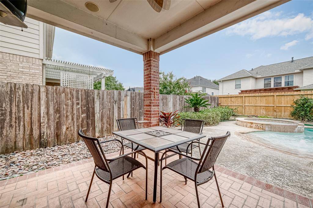 This cozy outdoor patio space provides the ideal space for your outdoor furniture set under the LED lit outdoor ceiling fans while you overlook your private backyard oasis. The area is fully covered, offering both shade and open sightlines to the entire outdoor space.