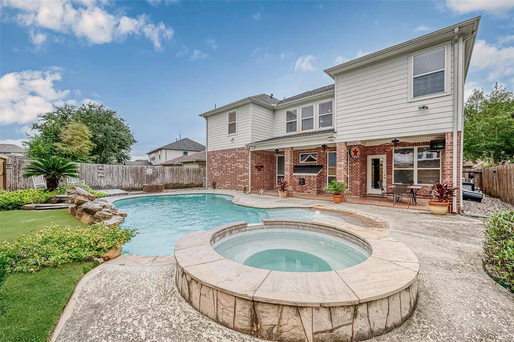 The backyard is overlooked by the home's fully covered back patio, cool-crete decking, and outdoor rated surround sound speakers for all your entertaining events throughout the year.  The heated swimming pool allows use throughout all the seasons.