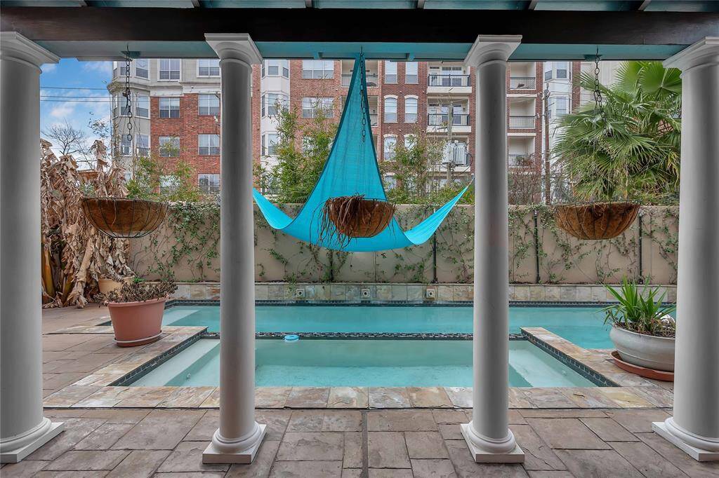 Outdoor space featuring a refreshing pool and a covered patio area.