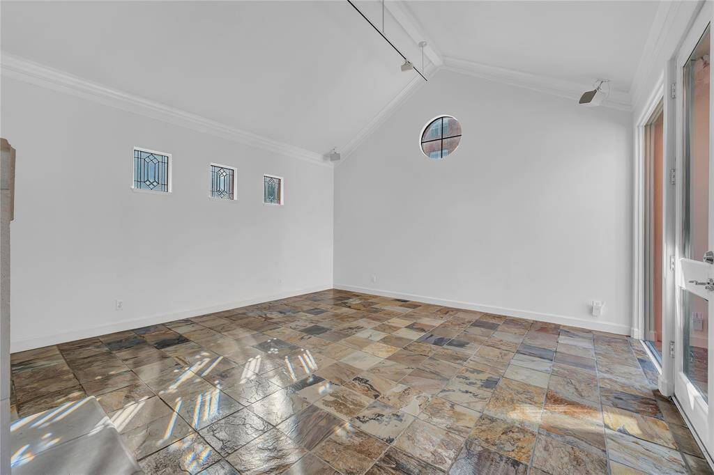 Another view of the formal living room with slate floors and vaulted ceilings.