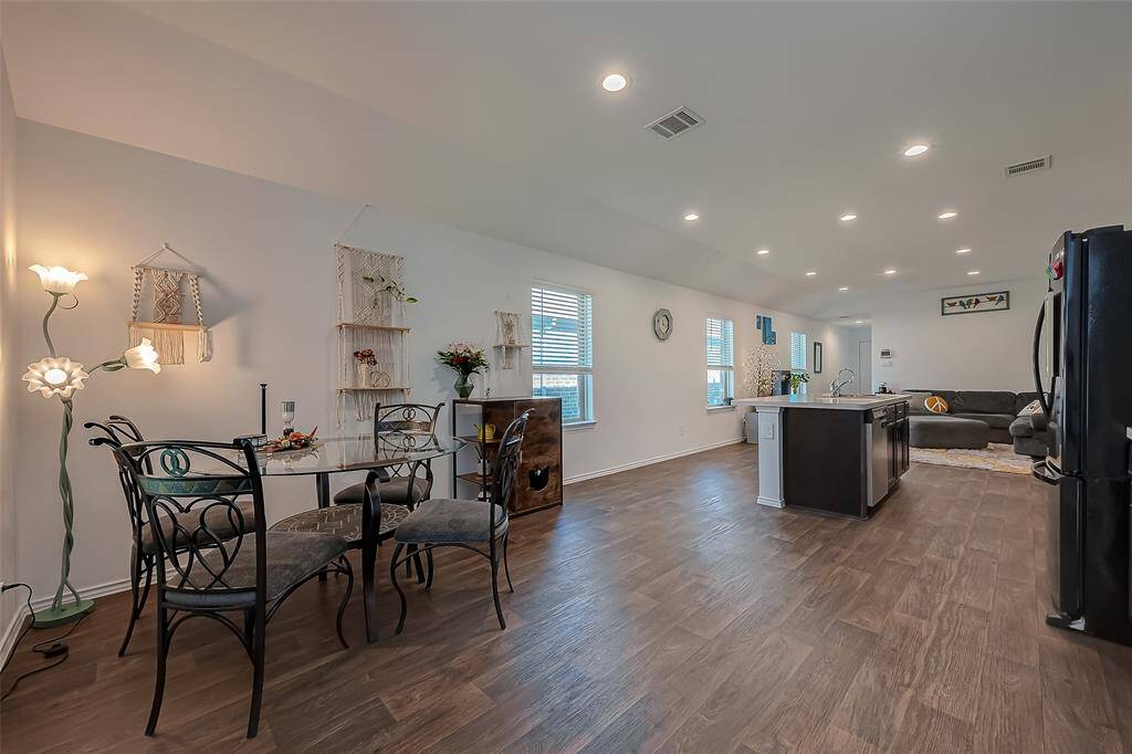 A view of the the dining area, kitchen, and living room.