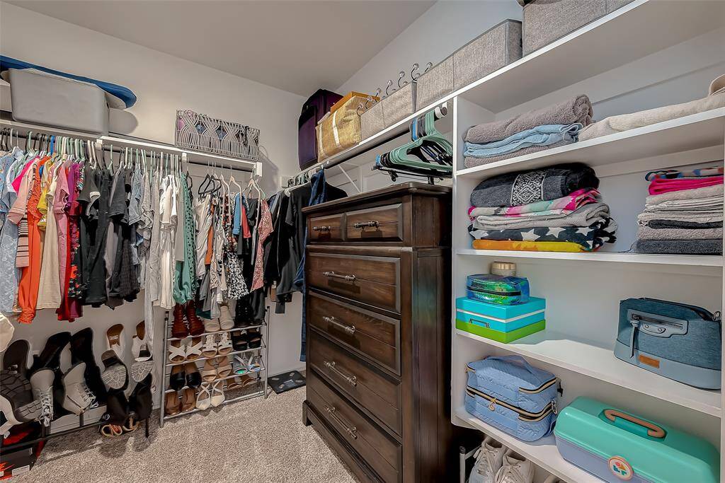 Primary bedroom walk in closet
