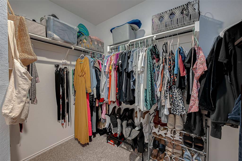 Primary bedroom walk in closet