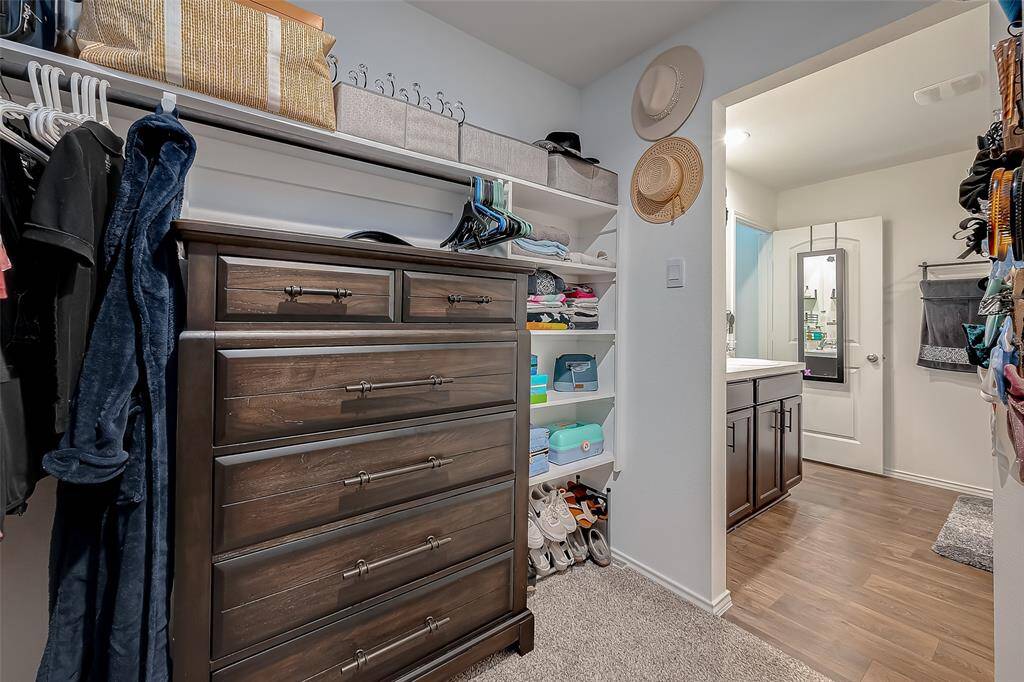 Primary bedroom walk in closet