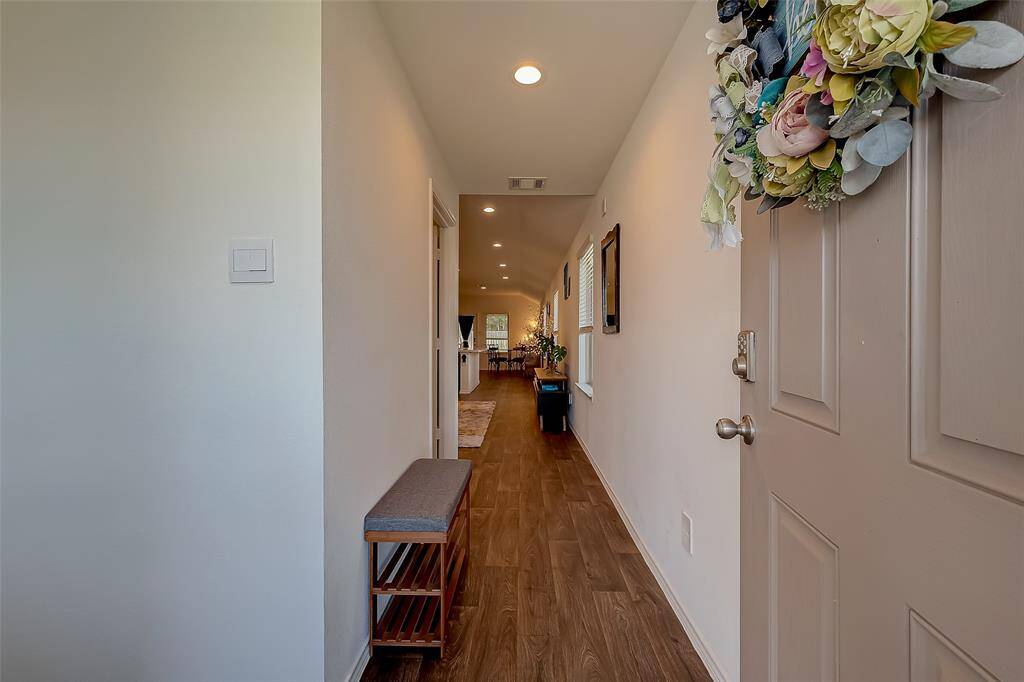 A hallway extending from the front door into the house.