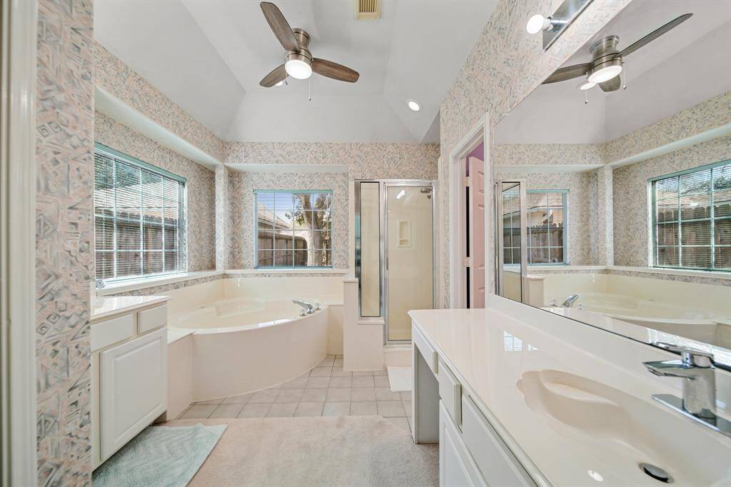 Primary bath with two separate vanities, a separate shower, and soaking tub.