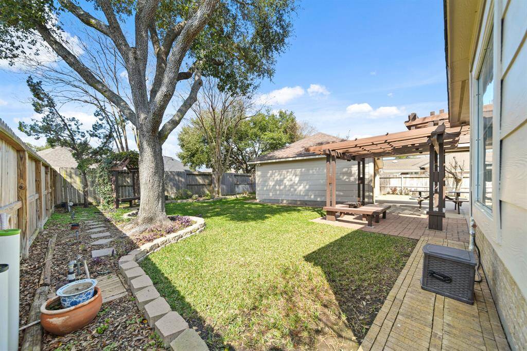 The backyard offers mature shade trees.