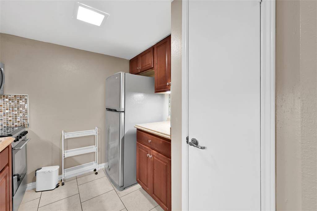 The kitchen offers a sterling steel fridge, German stove and plenty cabinets for storage.