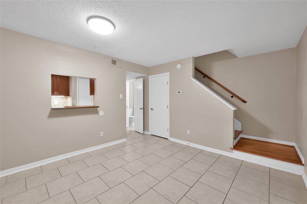 The dining room features a pass-through window to the kitchen, enhancing openness and easy meal access.