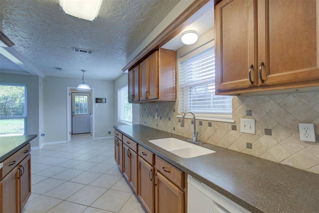 A view of the back entry way from the kitchen. Corian counters, fantastic soft closing cabinets and drawers, and pull our drawers in the bottom cabinets for pots and pans!