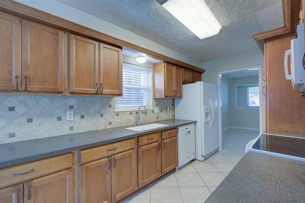 Corian counters, soft closing cabinets and drawers. Tile floor and tile backsplash! Refrigerator stays with the house.
