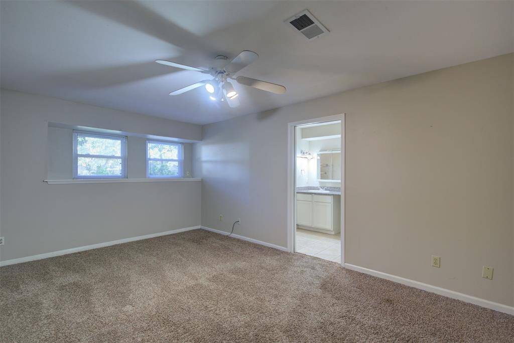 Another view of the primary bedroom with a peek into the bathroom.