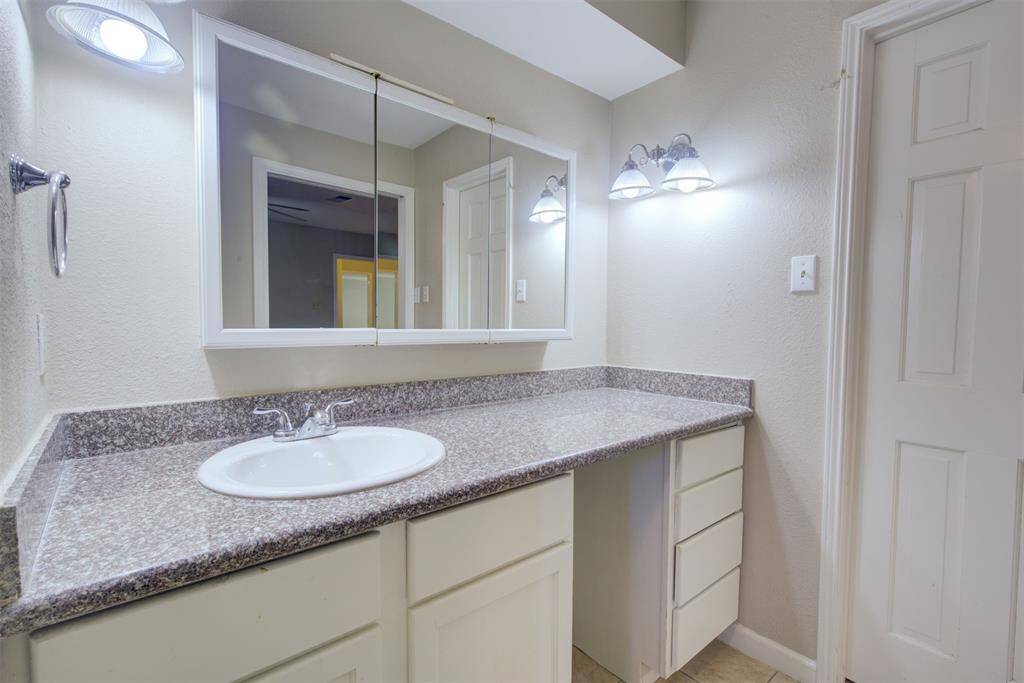 Primary bath with large vanity area, updated counter and lighting!