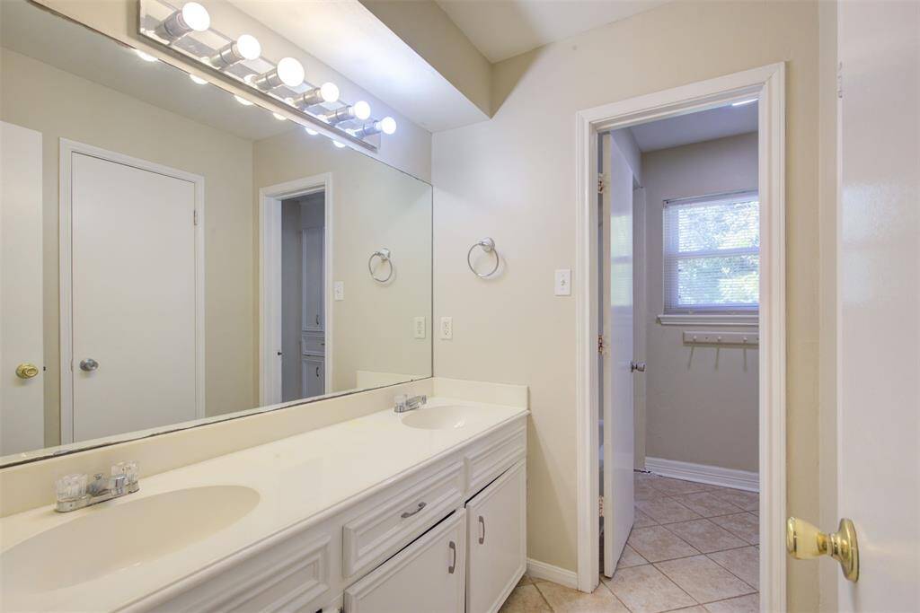 The secondary full bathroom is located upstairs and shared by the four secondary bedrooms. Tile floors, double sinks, tub/shower combo!