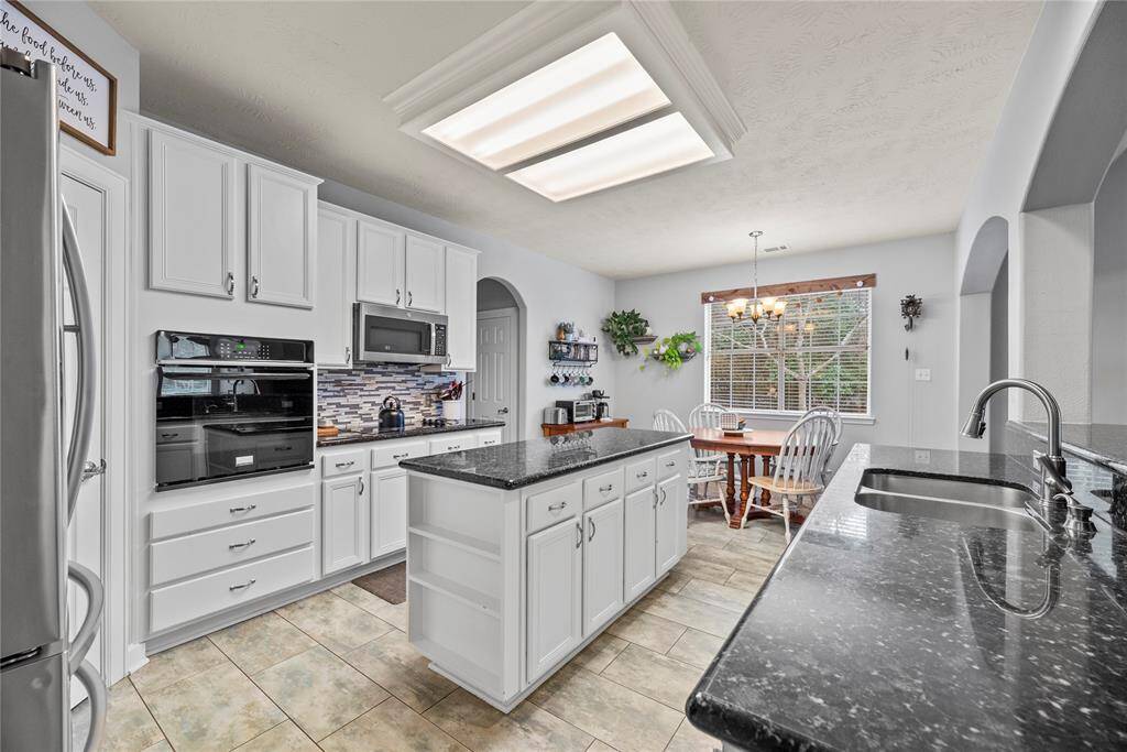Meal prep and cleanup will be a snap with the upgraded sinks, an automatic dishwasher, electric cooktop, built-in oven and microwave, and plenty of room for your sous chef and cleanup crew.
