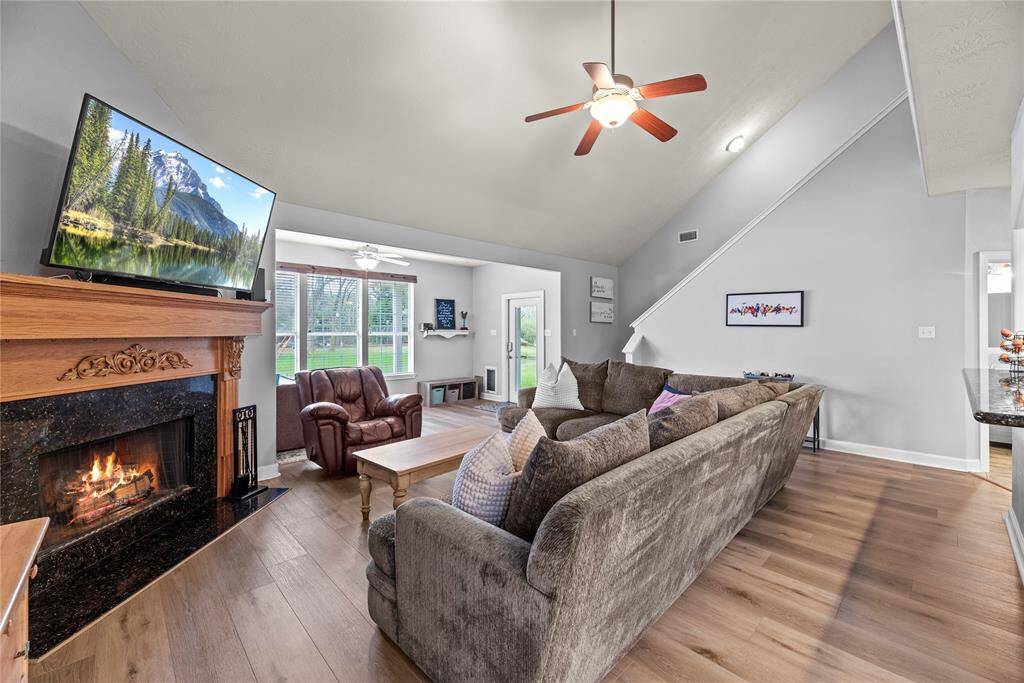 This spacious family room features a romantic gas-log fireplace and plenty of room for large comfortable furnishings. What a great spot to cozy up by the fire and unwind. Breathe, you are home now.