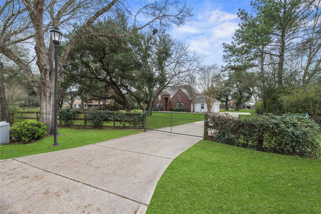 A gated entrance welcomes you to this stunning estate nestled among mature trees on over an acre. This beautifully maintained property provides a serene retreat with plenty of space to enjoy the outdoors.