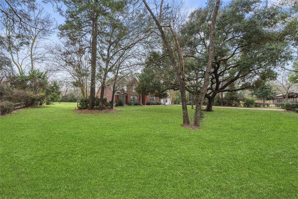 This stunning home is perfectly situated on over an acre (approx. 1.15 acres) of beautifully landscaped, gated/fenced land. Surrounded by mature trees and open green space, this property offers a rare combination of privacy, serenity, and ample room to enjoy the outdoors.