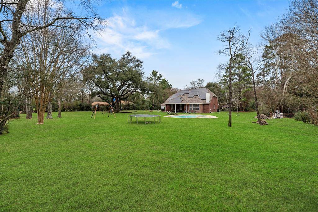This sprawling fenced yard is ready for barefoot fun with plenty of grassy lawn for outdoor play.