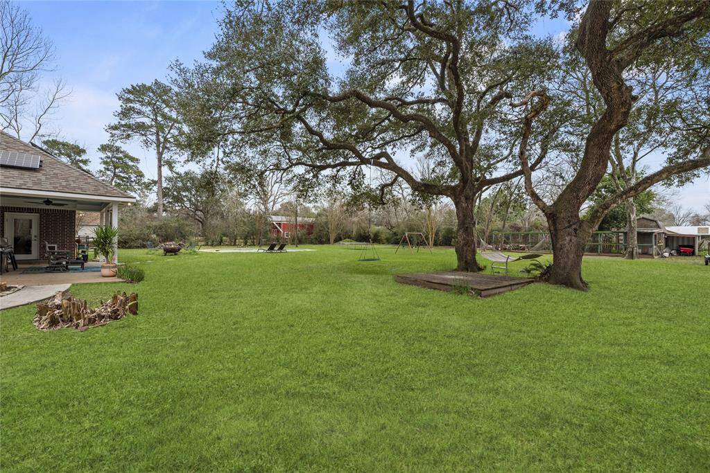 You’ll love the towering trees scattered throughout this sprawling property. This unique estate also features an aerobic sprinkler system, owned solar panels for energy efficiency, a charming chicken coop with egg-laying hens, a covered patio and a sparkling heated pool and spa.