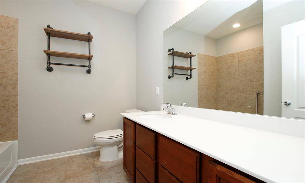 Secondary bath located off the entry hallway for convenience
