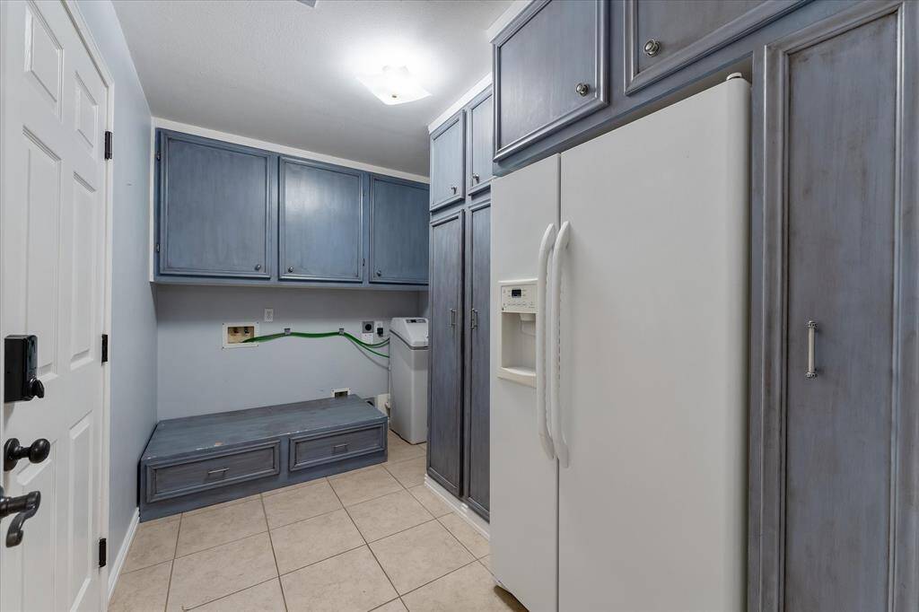 Laundry room with garage access. Tons of storage space and even includes a custom stand for front load washer and dryers!!