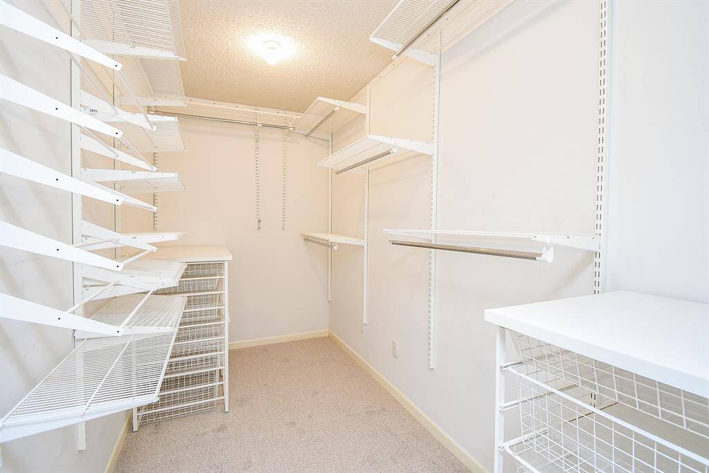 Looking back towards the primary bedroom closet.  There is also a recessed area with a full wall dressing mirror.