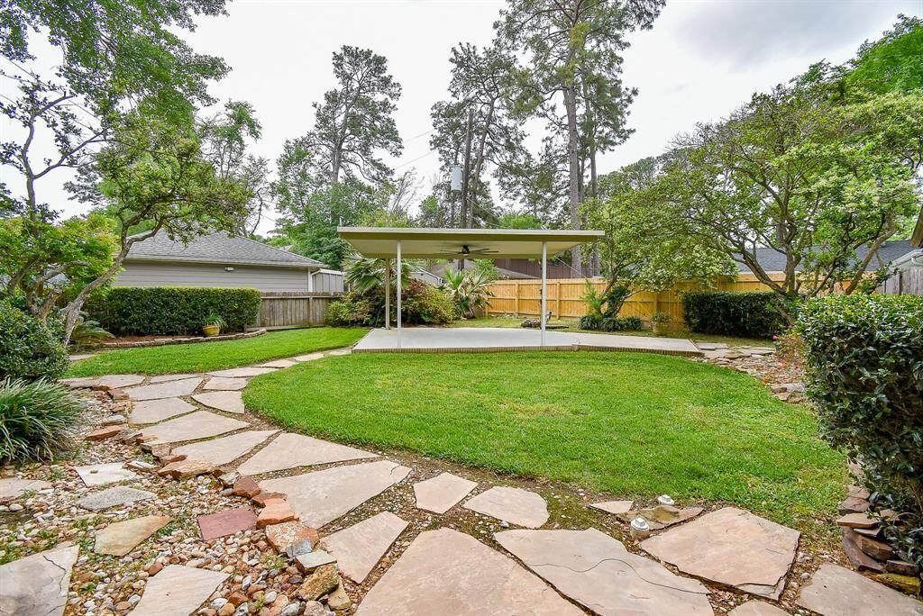 The outdoor covered porch is between the garage and kitchen.  Family and friends can come in through the door sized gate from the driveway. (virtually staged)
