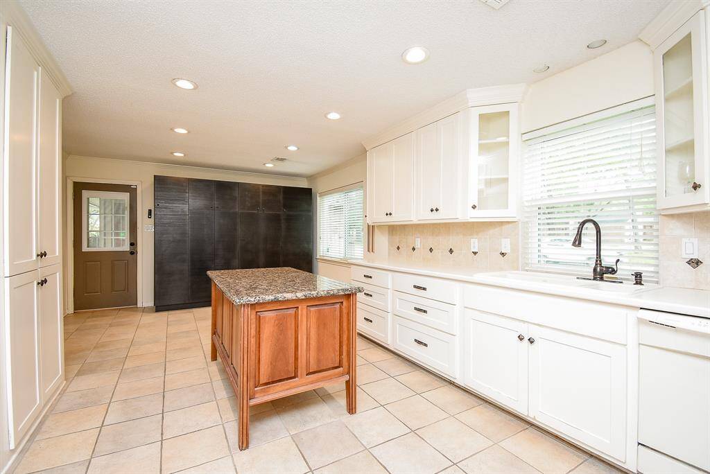 This is a great flex space. Game room.  Wine room. Gathering room. Office. Play room.  You choose. This great space has built in shelves and drawer storage.  The plumbing is also still accessible from the removed wet bar. (Virtually staged)
