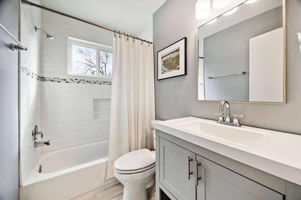 Shared guest bath includes tub/shower combo and modern finishes.