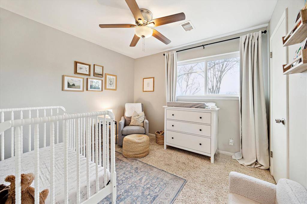 Adorable guest bedroom overlooks the treetops.