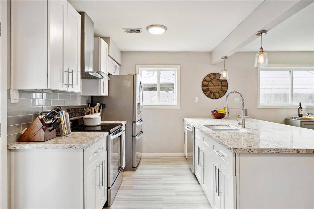 Kitchen is well equipped with all of your culinary needs. Note the tasteful hardware and light fixtures.