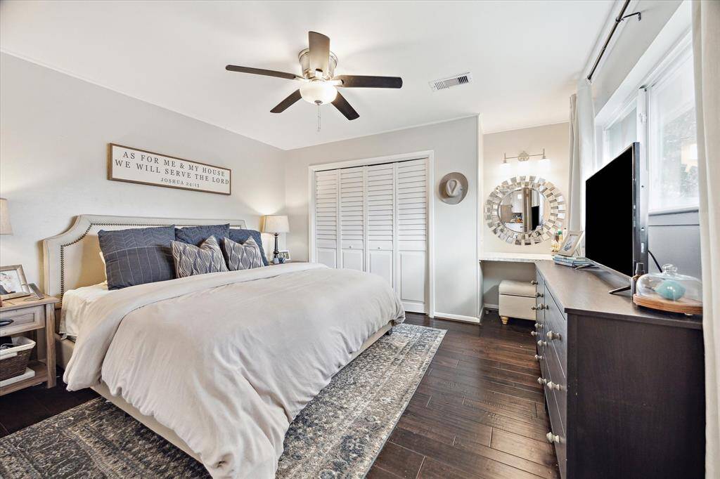 First floor primary suite features engineered hardwoods, wall closet, and separate vanity space.