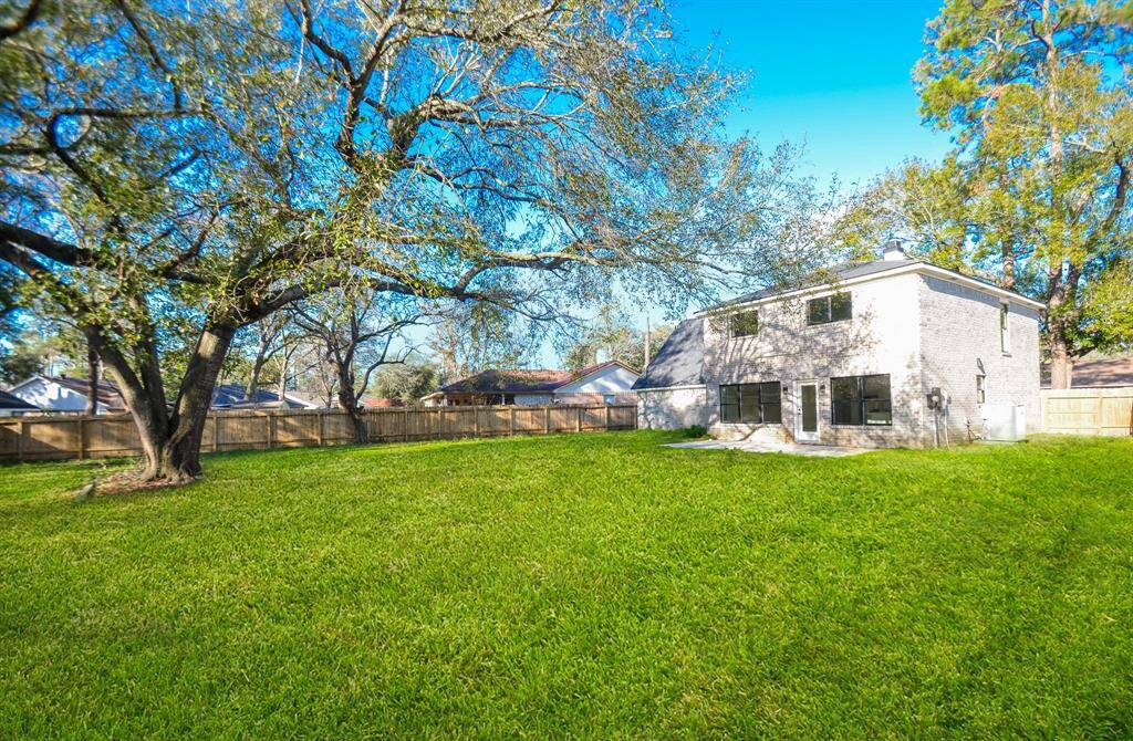 The lush green grass provides ample space for little ones to play, pets to roam, or for you to create your dream garden.