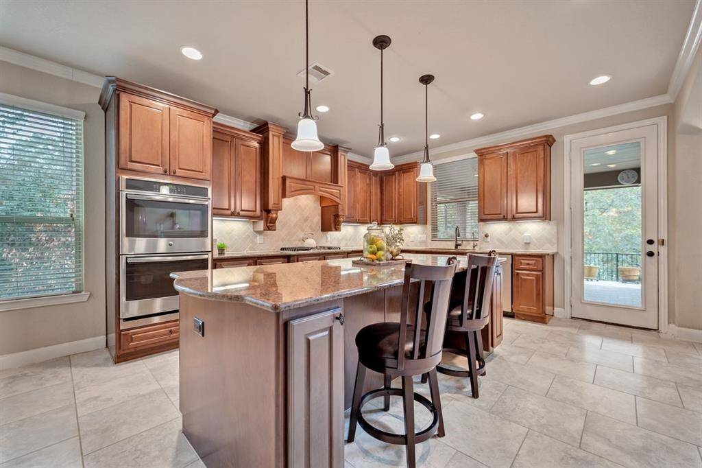 The kitchen features a large breakfast bar with ample storage!