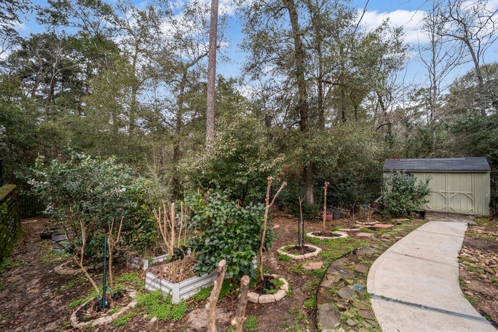 Lush greenery, peaceful retreat, and secluded oasis with flowing trees and shrubs offering a variety of color.