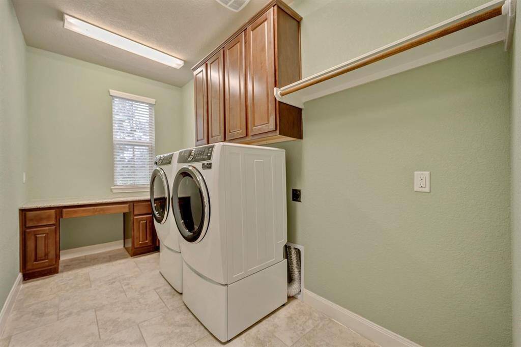 Oversized laundry room with desk