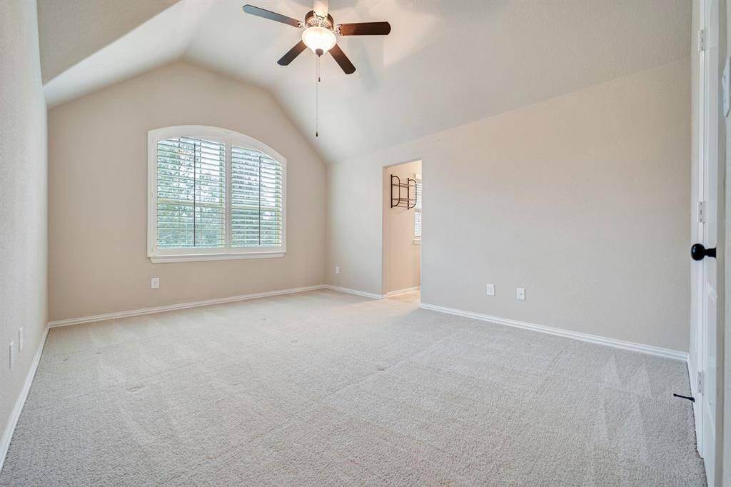 Tall ceilings and plantation shutters are featured in this property.