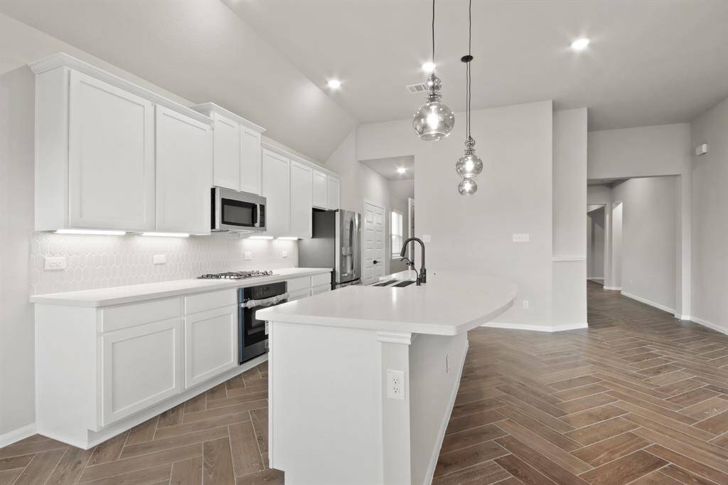 Lovely kitchen with quartz countertops and white cabinets