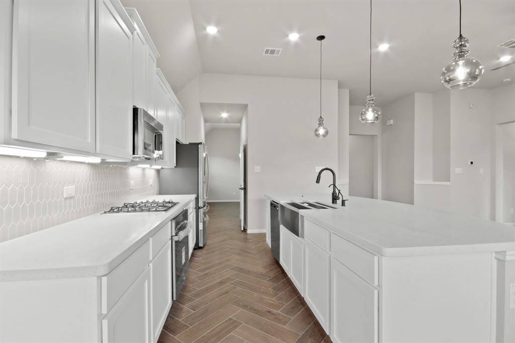 Stainless appliances and brushed nickel accents in kitchen
