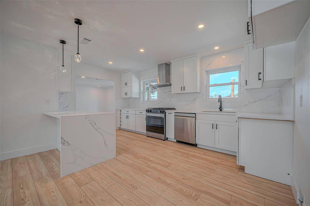 Step into the heart of this home with a sleek kitchen featuring a brand-new Samsung gas cooktop and dishwasher, along with soft-closing cabinets and drawers.