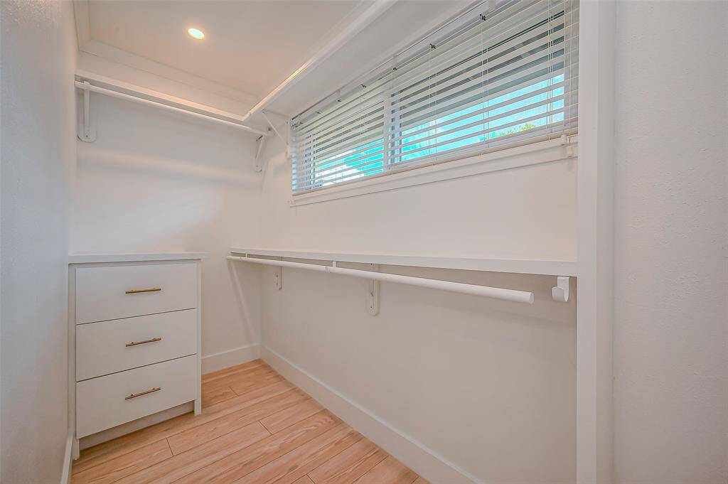 Newly renovated primary walk-in closet, offering ample space and organization for all your wardrobe needs.