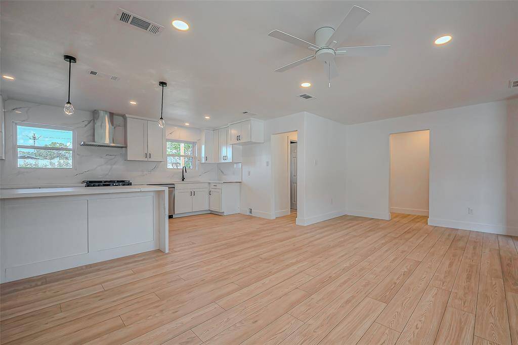 Living room flows effortlessly into the modern kitchen, perfect for entertaining and everyday comfort.