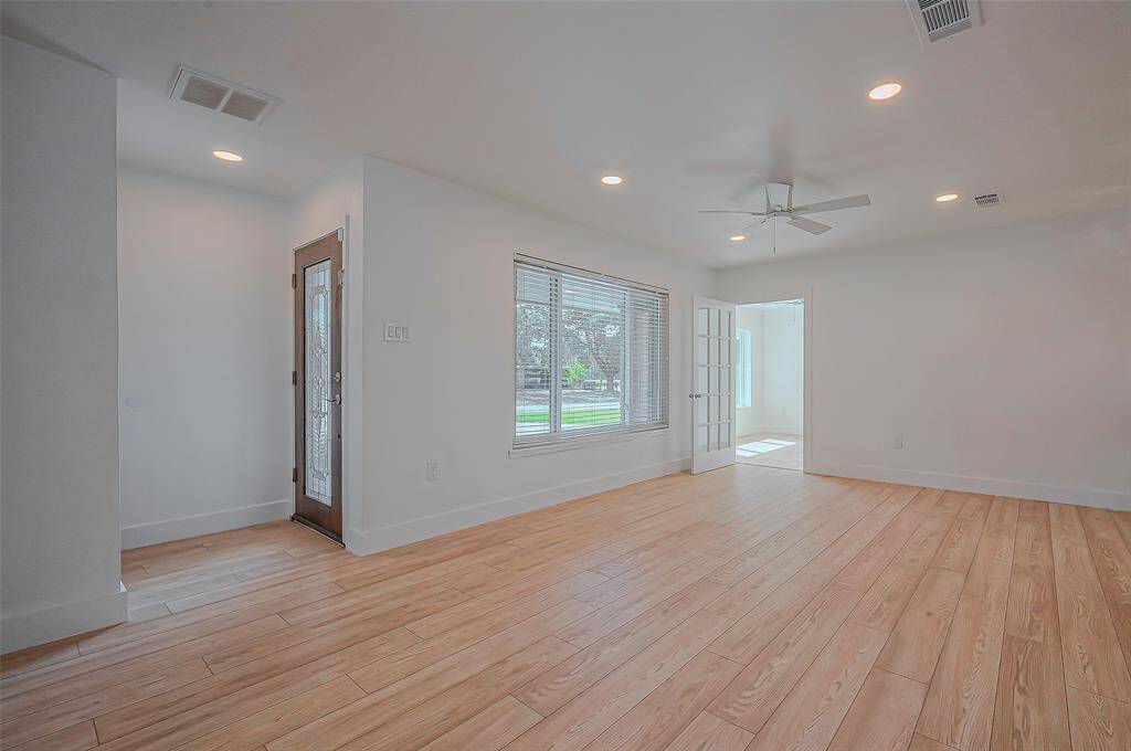 Step into the inviting front entrance, highlighted by a large window that floods the space with natural light, creating a warm and welcoming atmosphere.